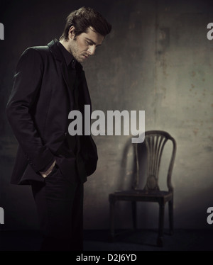 Handsome and calm man in a business suit on a dark background Stock Photo