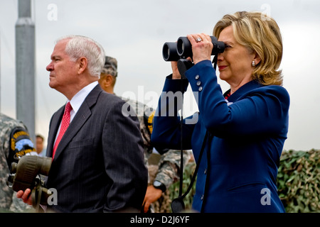 Secretary of State Hillary Clinton and Defense Secretary Robert Gates look out over North Korea from Observation Point Ouellette during a tour of the Demilitarized Zone in Korea July 21, 2010. Stock Photo