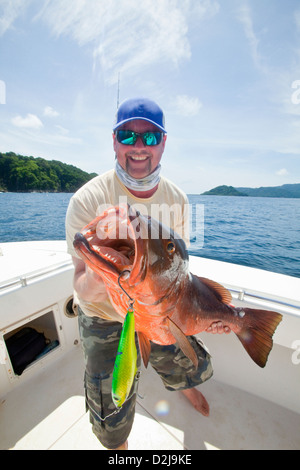 Man holds cubera snapper (lutjanus cyanopterus); panama Stock Photo