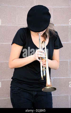 Female trumpet player blowing . Stock Photo