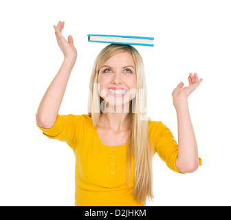 Happy student girl balancing book on head Stock Photo