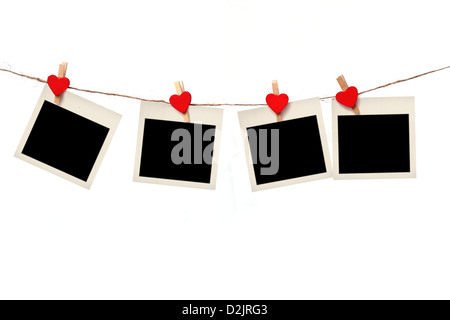 blank instant photos hanging on the clothesline. Isolated on white background. Stock Photo