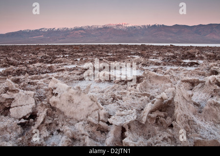 Salt crystals at Badwater below early light on the Panamint Range, Death Valley National Park, California. Stock Photo