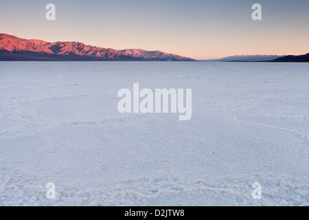 Early light on the Panamint Range above Badwater Basin and the salt pan polygons, Death Valley National Park, California. Stock Photo