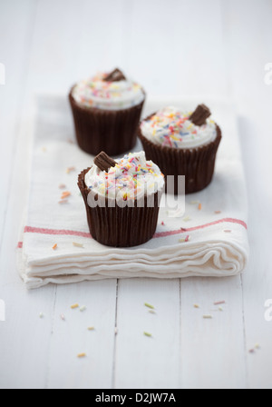 Cupcakes decorated with sprinkles and a chocolate flake Stock Photo