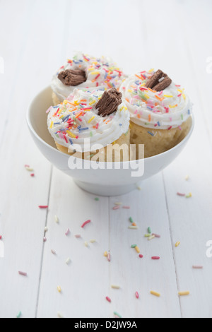 Cupcakes decorated with sprinkles and a chocolate flake Stock Photo