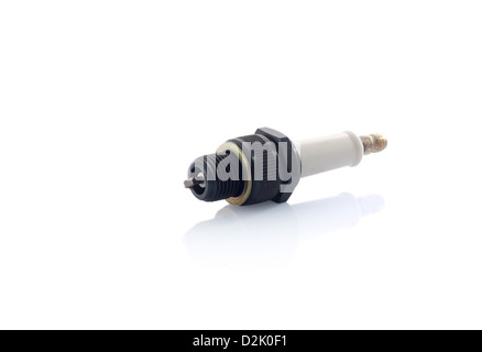 Old white ceramic and plastic spark plug isolated on white with reflection Stock Photo