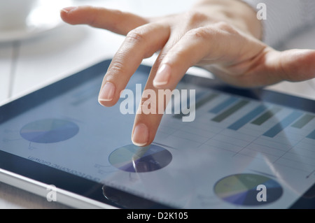closeup of finger touching screen on tablet-pc with shallow depth of field Stock Photo