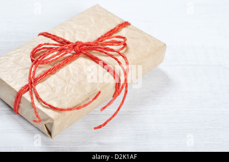 Vintage gift box with red ribbon on wooden background closeup Stock Photo