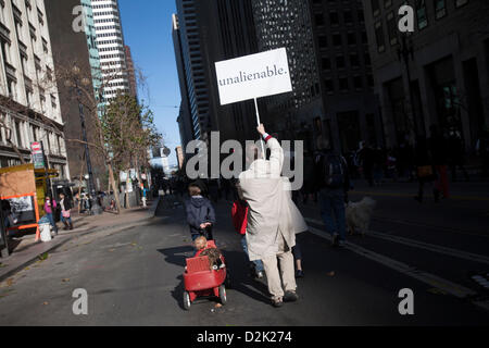 San Francisco. Jan 26th, 2013. A pro life supporter walks down the street carrying a sign at the end of the west coast 'walk for life' rally in San Francisco January 26, 2013. Stock Photo