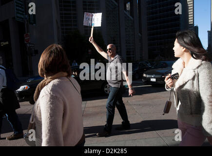 San Francisco. Jan 26th, 2013. A pro life supporter carries a sign that reads, 'real men defend life' at the end of the west coast 'walk for life' rally in San Francisco January 26, 2013. Stock Photo