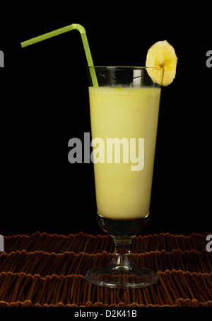 Banana milk shake and fresh fruit banana. Cocktail with milk. White isolated glass of milkshake. Stock Photo