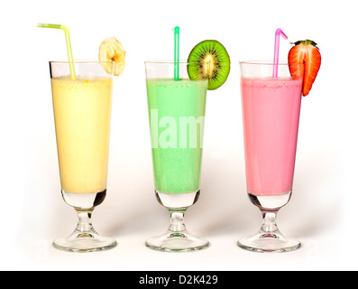 Banana, kiwi and strawberry milk shake and fresh fruis. Cocktail with milk. White isolated glass of milkshake. Stock Photo