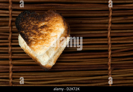 Toast with heart-shaped on wooden background. Copy space Stock Photo