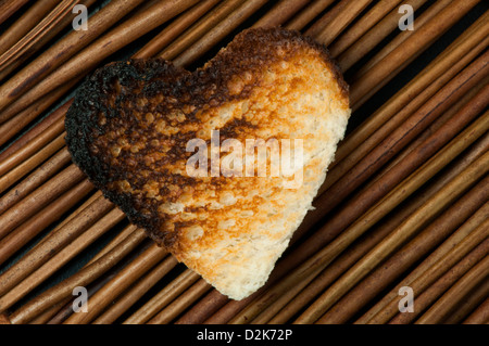 Toast with heart-shaped on wooden background. Copy space Stock Photo