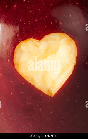 Heart shape closeup carved in red apple Stock Photo