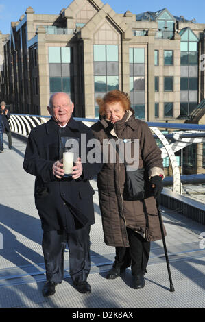 Millenium Bridge, London, UK. 27th January 2013. Ben Helfgott, a survivor of the Holocaust, holds a candle lit in remembrance of those who died, as the Holocaust Memorial Day commemoration takes place at the Millennium Bridge. A choir and survivors of the Holocaust took part in the ceremony. Credit: Matthew Chattle/Alamy Live News Stock Photo