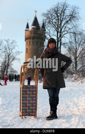 A woman stands in front of the Brandenburg Gate with a sling around her ...