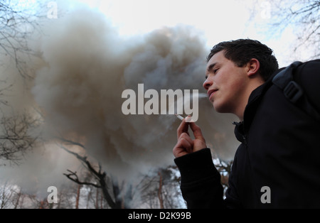 Wandlitz, Germany, Smoking Man in front of a large cloud of smoke Stock Photo