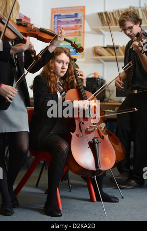 A girl with a cello during an orchestra practice at Pates Grammar School in Cheltenham, Gloucestershire UK Stock Photo