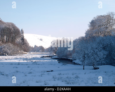 Stream running through a valley in snow, Exmoor, Somerset, UK. January 2013 Stock Photo