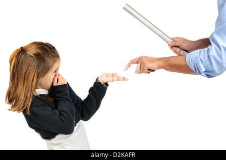 Young girl being physically punished by teacher with a ruler Stock Photo