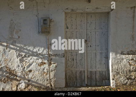 Old front door in weathered house front (Greece) Stock Photo