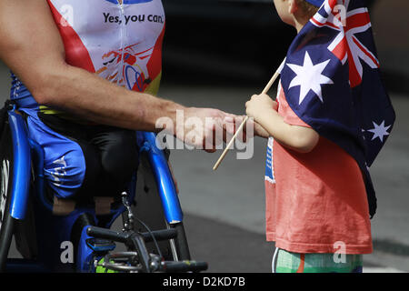 Jan. 26, 2013 - Sydney, Australia - January 26, 2013 - Sydney, Australia - London 2012 Paralympics medal winner, Kurt Fearnley, got a congratulation from his kid fans after he won the first place of GIO Oz Day 10K wheelchair race, as a part of celebrating Australia Day 2013,on January 26,2013 in Sydney, Australia. Australia Day, formerly known as Foundation Day, is the official national day of Australia and is celebrated annually on January 26 to commemorate the arrival of the first fleet to Sydney in 1788. Australia Day today is a celebration of diversity and tolerance in Australian society.  Stock Photo