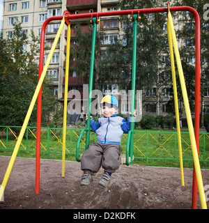 little boy teeter on playground at autumn Stock Photo