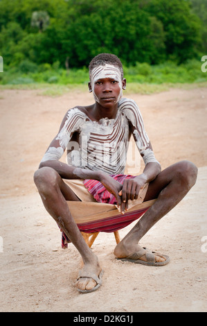 Portrait of decorated Kara young man sitting down Stock Photo