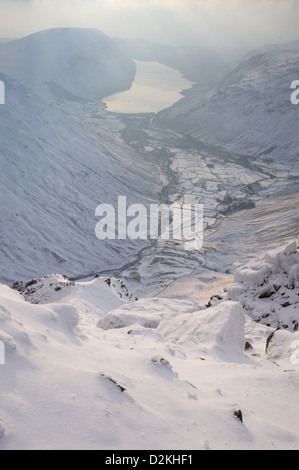 View over Wasdale and Wast Water from next to the Westmorland Cairn on the summit of Great Gable in winter in the English Lakes Stock Photo