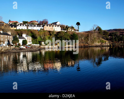 Houses above the harbour of Portree, in the Scottish Isle of Skye, reflected in the water. Stock Photo