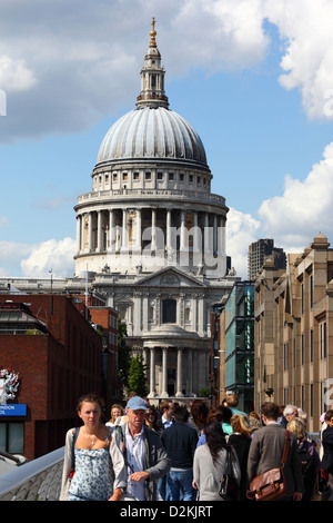 People walking across London Millennium Footbridge, dome of St Paul's Cathedral in background, London, England Stock Photo