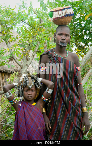 Mursi woman with child alongside Stock Photo