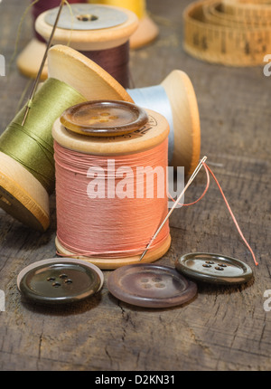 Buttons and needles with spools of sewing thread Stock Photo