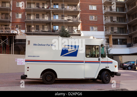 USPS delivery truck parked in front of apartment building - Arlington, Virginia USA Stock Photo