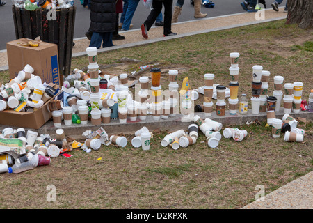 Discarded coffee cups overflowing from trash bin on public street Stock Photo