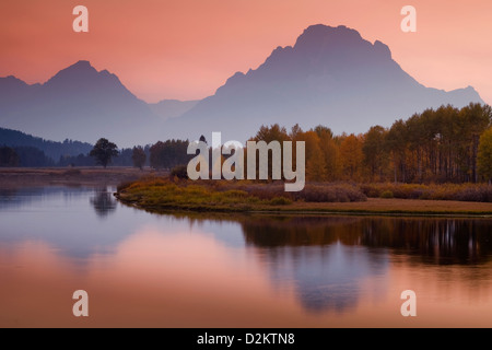 Mist creates drama after the sun has set behind the mountains of Grand Teton National Park at Autumn as viewed from Oxbow Bend. Stock Photo
