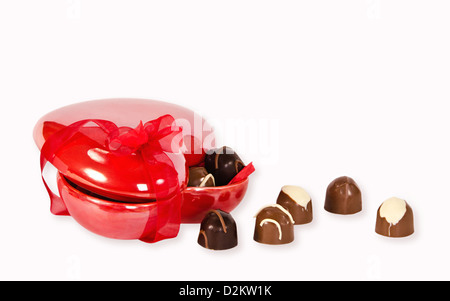 Chocolate candies in heart shaped box with red ribbon Stock Photo