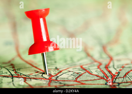 Red push pin on a tourist map for travelling Stock Photo