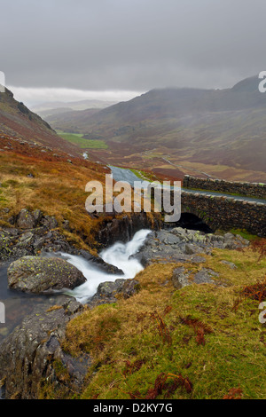 Looking down the valley from the old stone bridge on the Wrynose pass in the Lake District, Cumbria, England Stock Photo