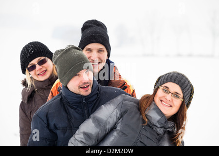 Group of young happy friends enjoying snow and winter. Stock Photo