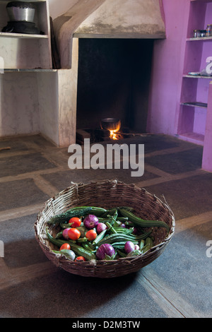 Basket of indian vegetables inside the kitchen of a rural indian village house. Andhra Prasdesh, India Stock Photo