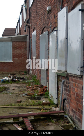 A row of former colliery homes boarded up and ready for demolition at Pleasley, Mansfield, North Nottinghamshire. Stock Photo