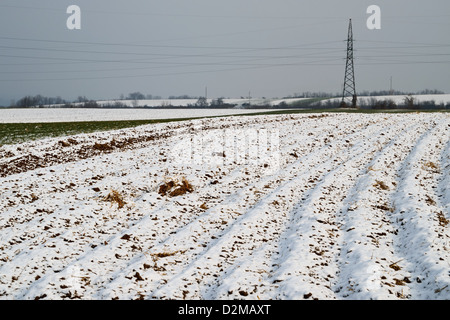 Plowed agricultural field covered with fresh winter snow Stock Photo