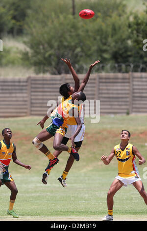 POTCHEFSTROOM, SOUTH AFRICA - JANUARY 28, 2 players jump for control of the ball during the AFL Game 1 match between the Flying Boomerangs and South African Lions under 18's at Mohadin Cricket Ground on January 28, 2013 in Potchefstroom, South Africa Photo by Roger Sedres / Image SA Stock Photo