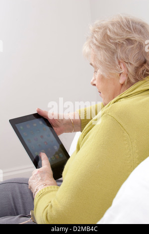 Mature lady using a digital tablet. Stock Photo