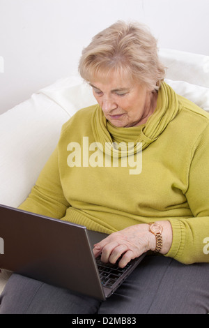 Mature lady using a laptop.