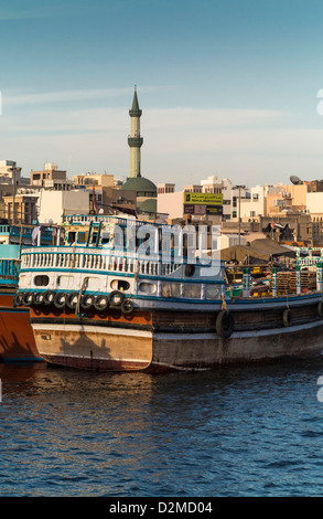 Dubai Creek - Traditional Arabian boats with old city behind Stock Photo