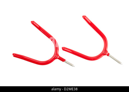 Two red plastic coated screw type tool storage hooks Stock Photo